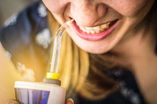 A woman using an oral irrigator