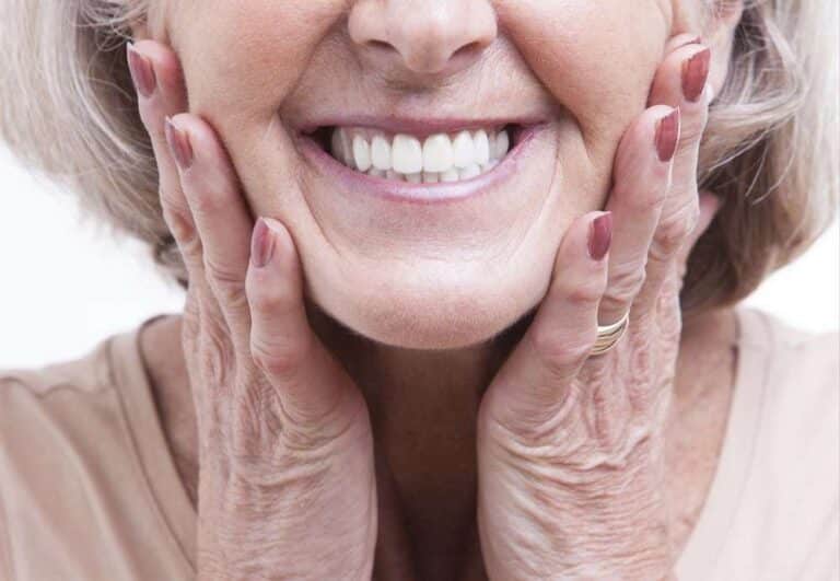 senior woman with dentures smiling