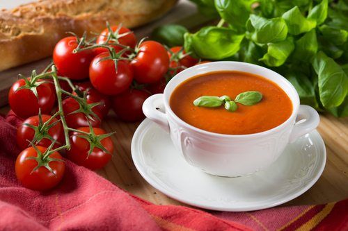 omato soup in a bowl with healthy and fresh ingredients