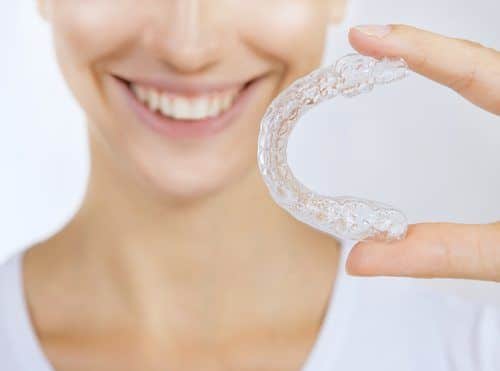 smiling girl with tooth tray