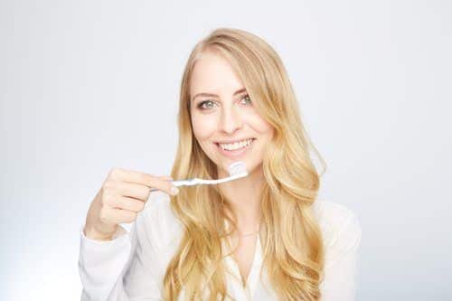 woman holding a toothbrush