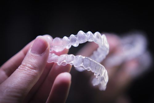 hand holding invisalign