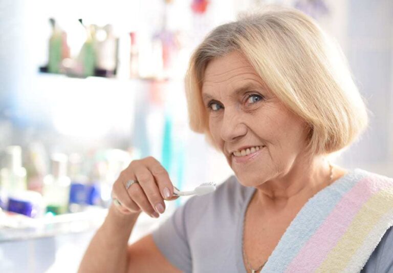 senior woman brushing teeth