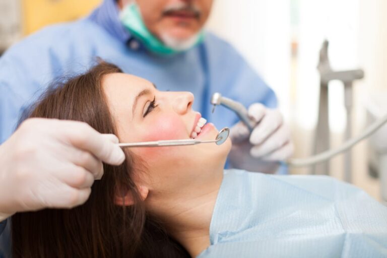 Woman-smiling-while-receiving-dental-treatment