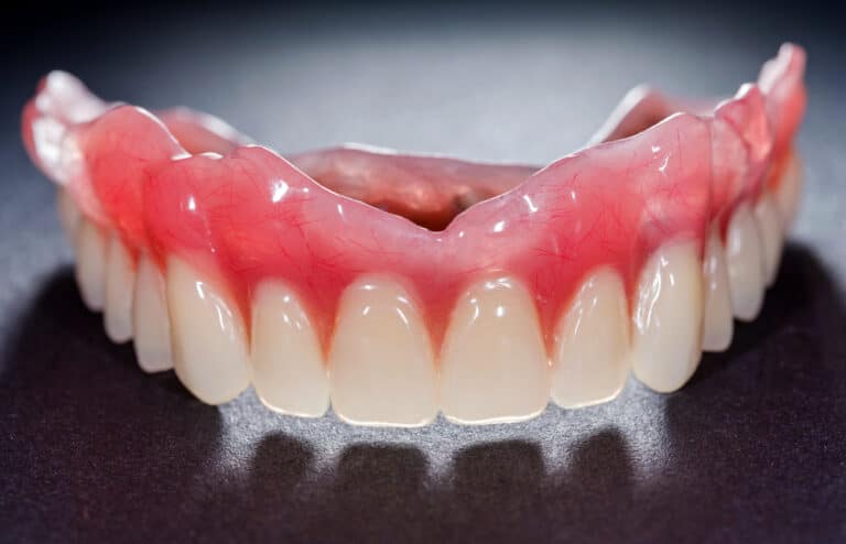 upper denture on dark surface