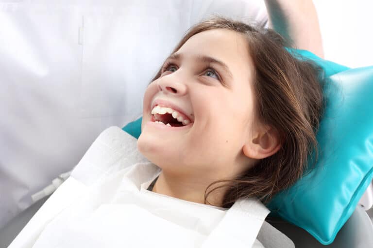 Smiling girl with in dentist's chair