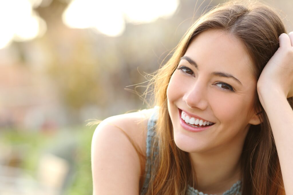 Smiling young woman with white teeth